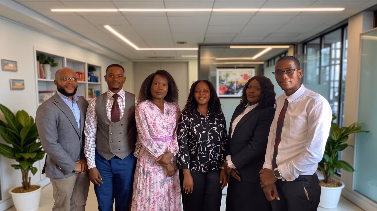 Professional team posing together in modern office with plants